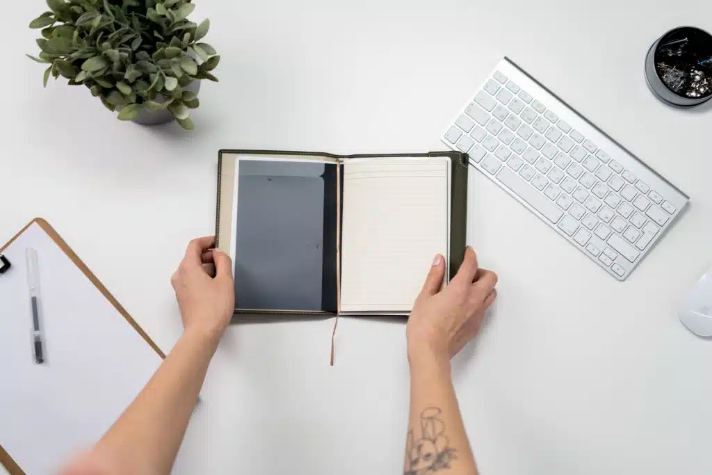 hands opening a planner notebook
