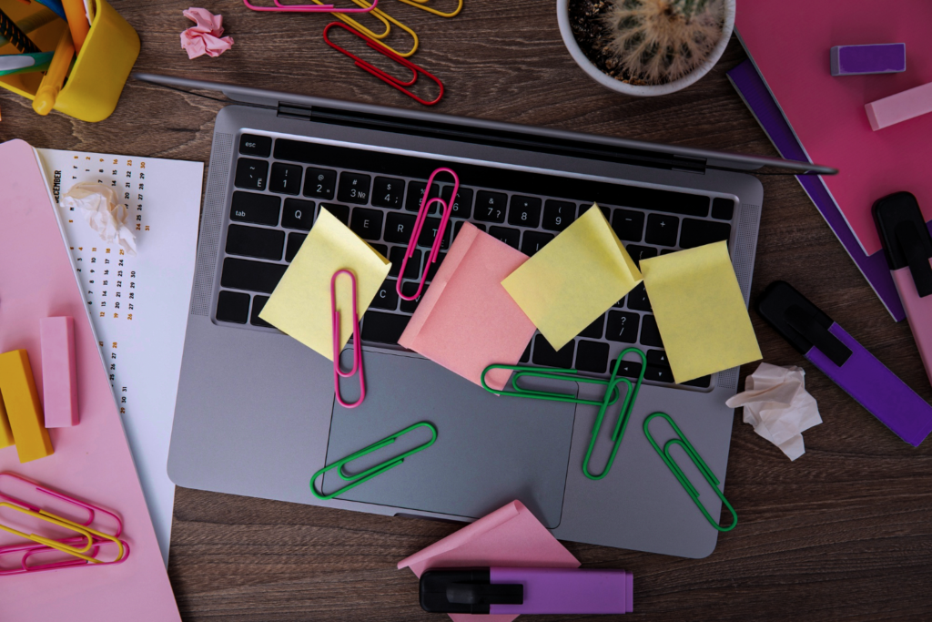 A top-down view of a laptop with a few post-it notes on it