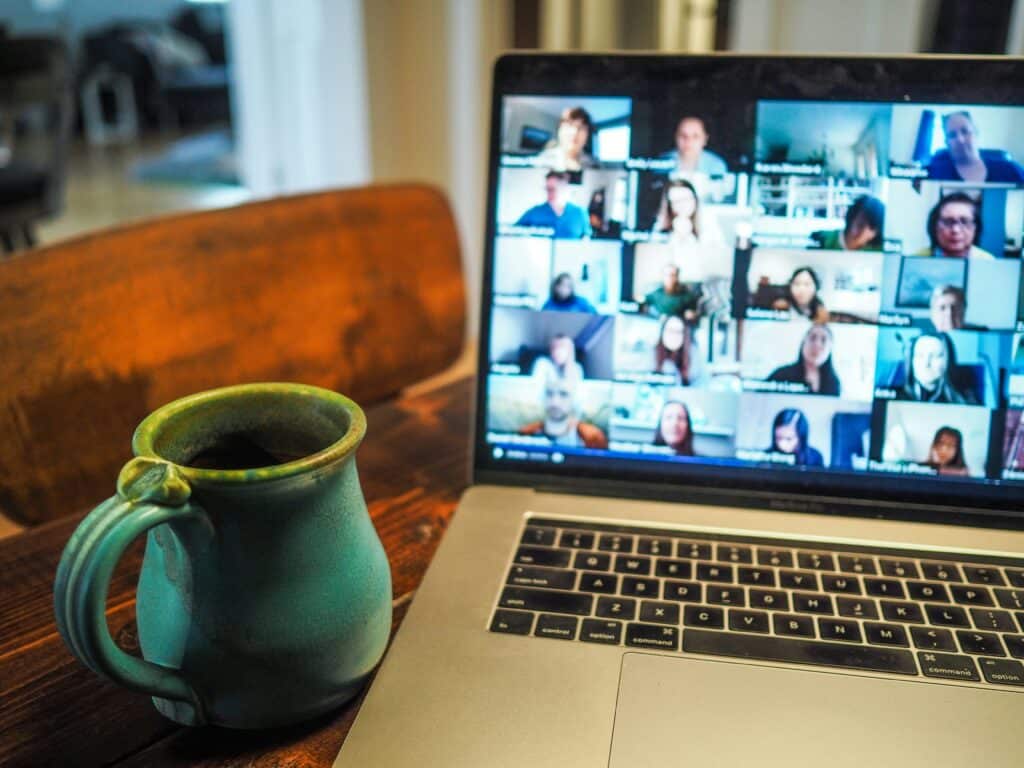 A blurry photo of a laptop displaying a form of remote collaboration, an online meeting