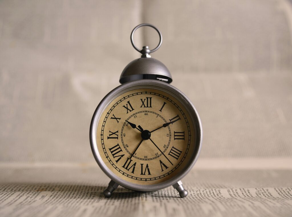 A shallow depth of field photo of a clock signifying the importance of time and preventing time theft.