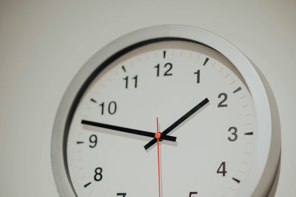 A close-up shot of a clock that may be used to track time to improve employee accountability.