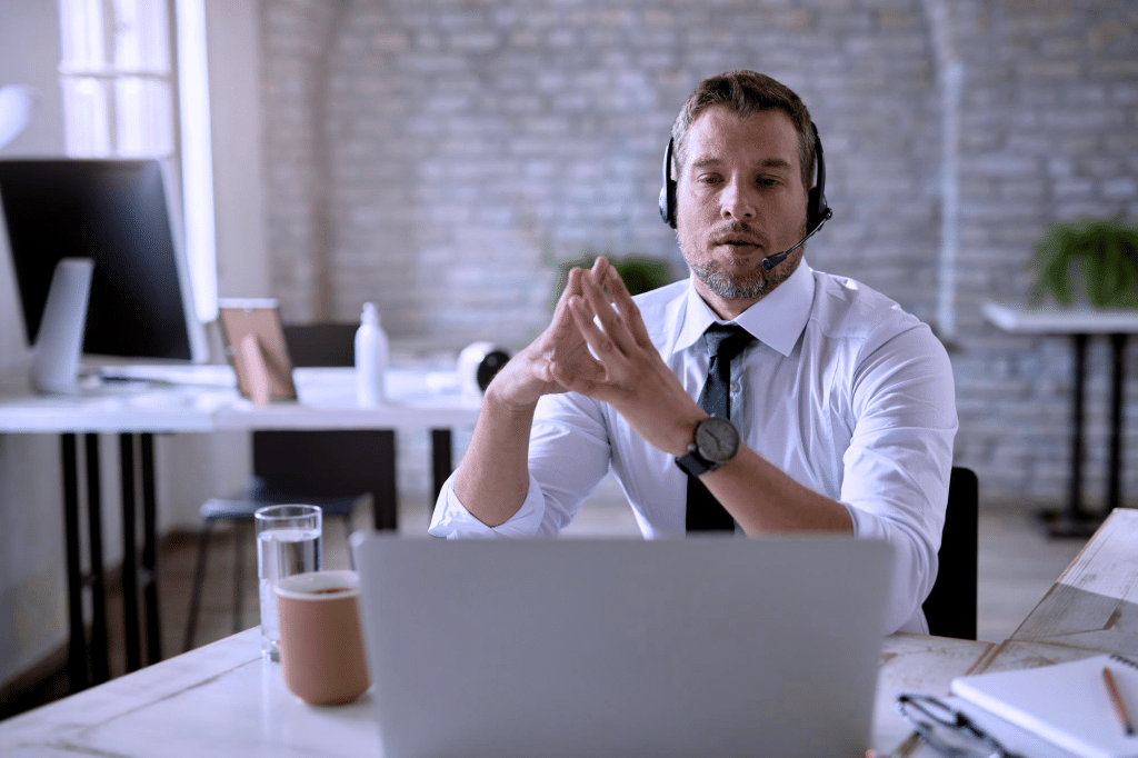 A high-depth-of-field image of a man having a video call on a laptop