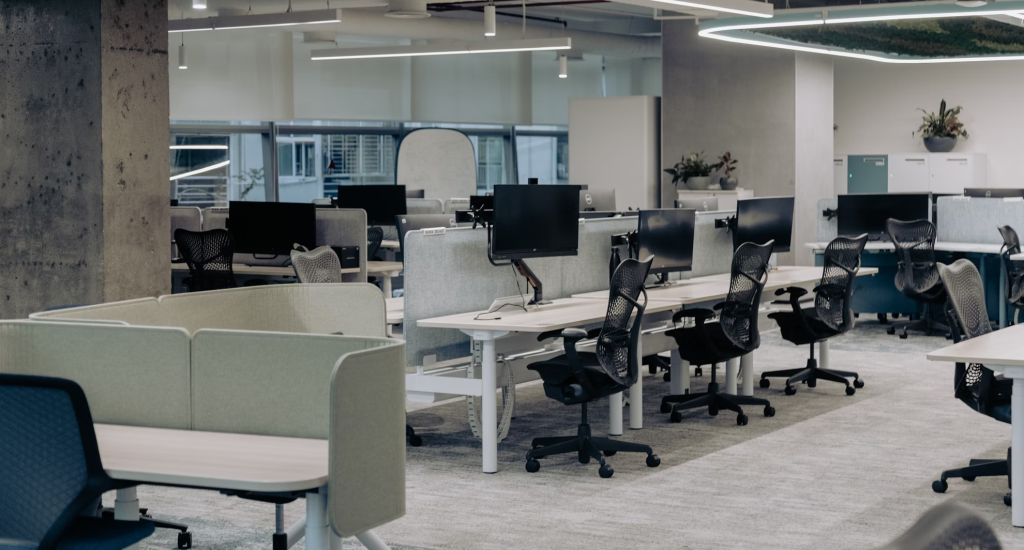 An empty modern, open-plan office depicting employee absenteeism.