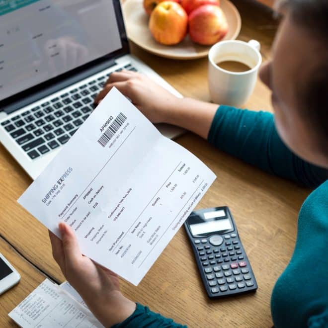 a woman looking at her weekly paychecks