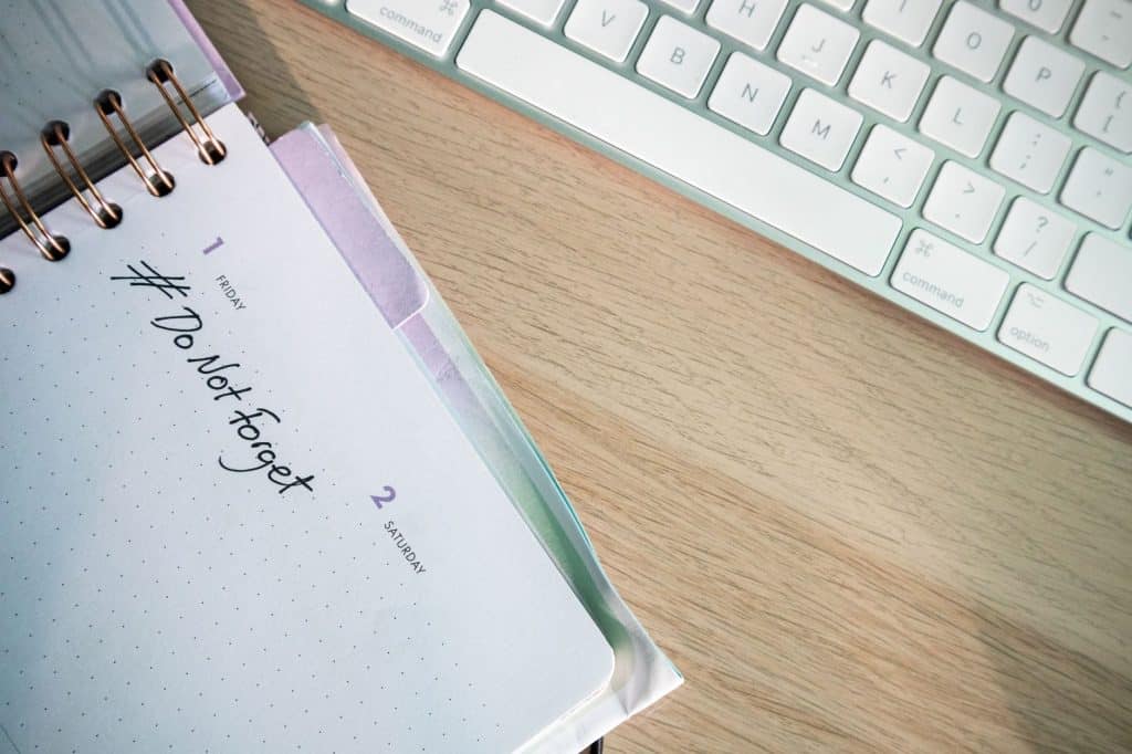 A close-up shot of a planner and keyboard on a desk, showcasing organization.