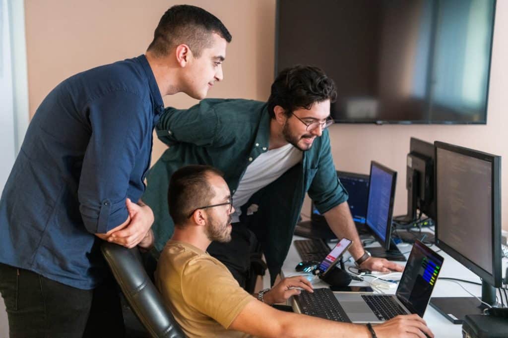 a team working next to the computer