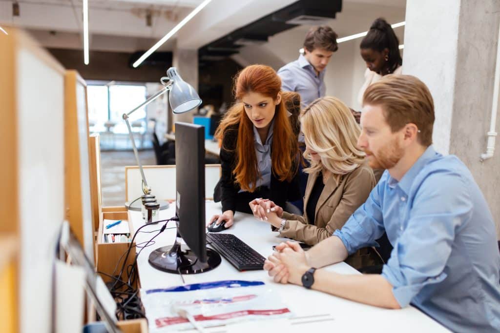 people working in the office- how to detect shadow AI usage in your team